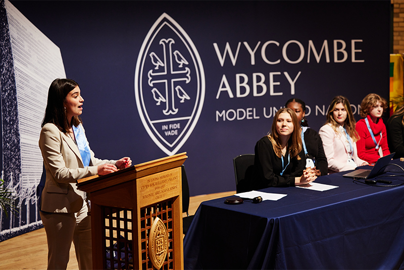 Wycombe Abbey girls speak at the lecturn of the MUN Conference