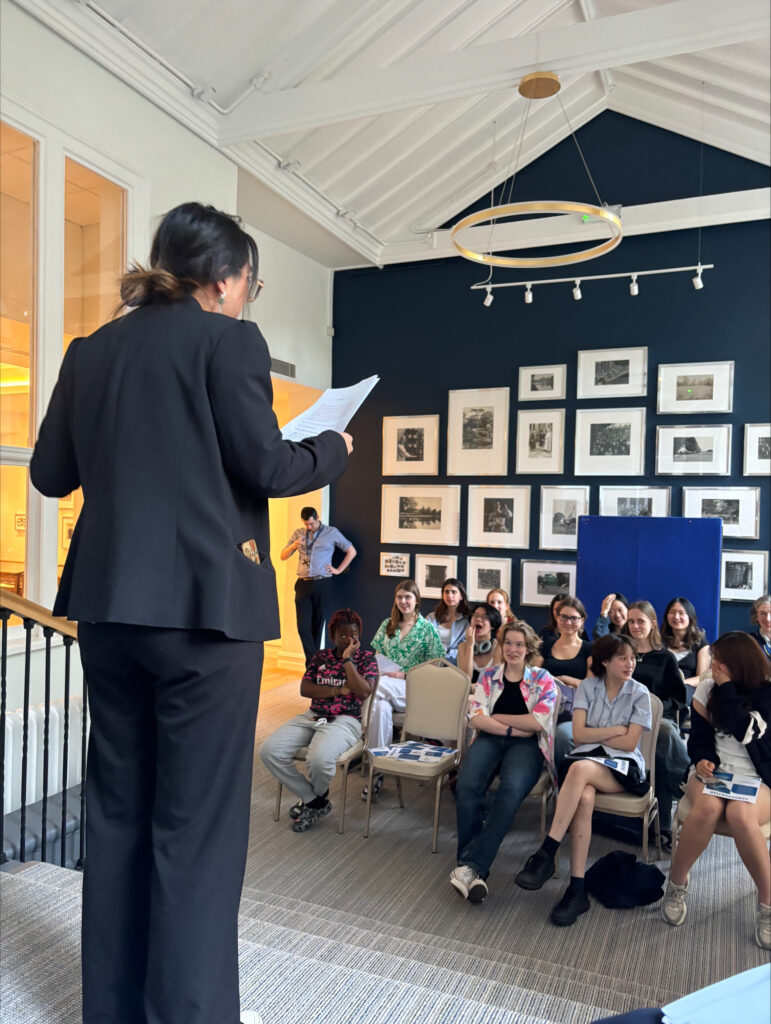 A pupils giving a speech to her fellow pupils.