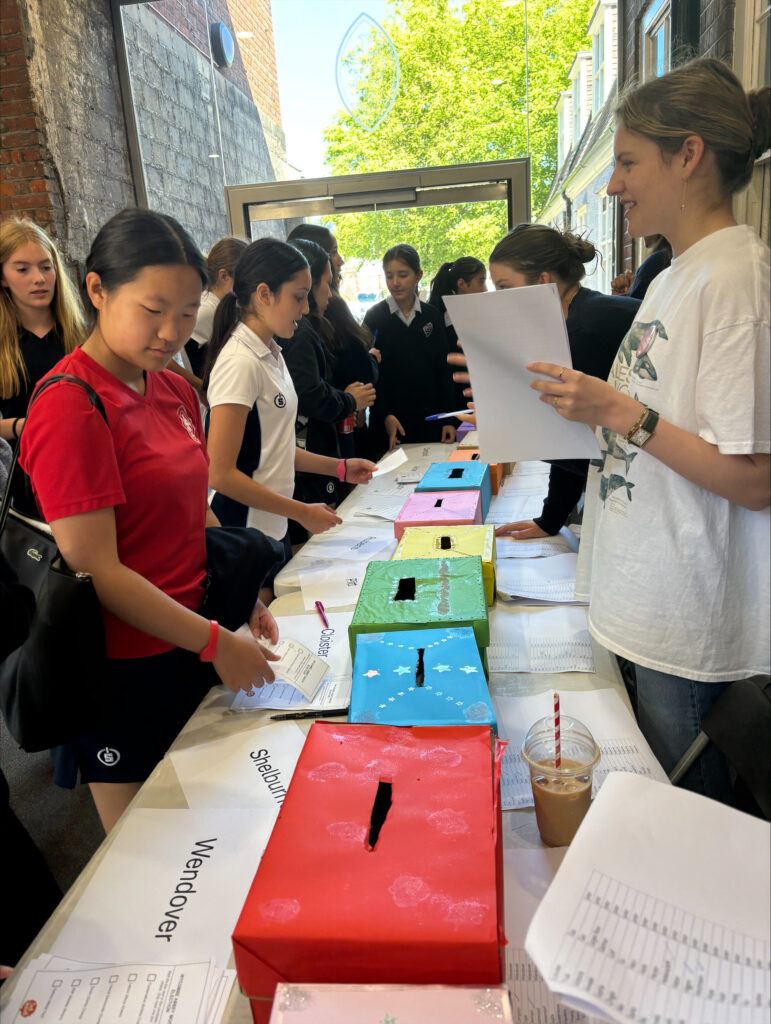 Pupils are queueing to put their vote in the ballot box.
