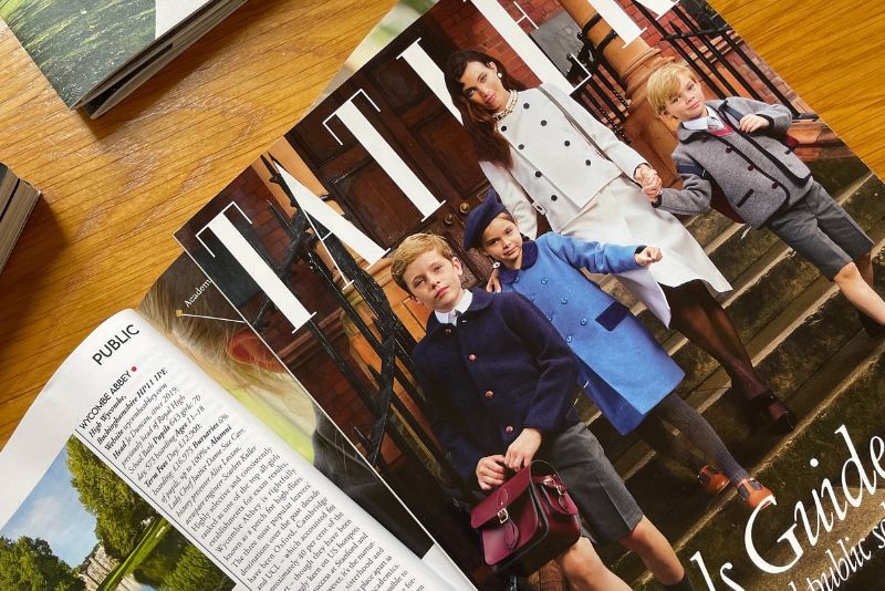 The front cover if the Tatler Schools Guide 2024. A mum is walking her three children down some steps.