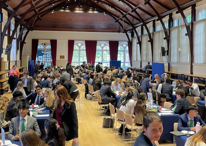 A busy school hall filled with girls.