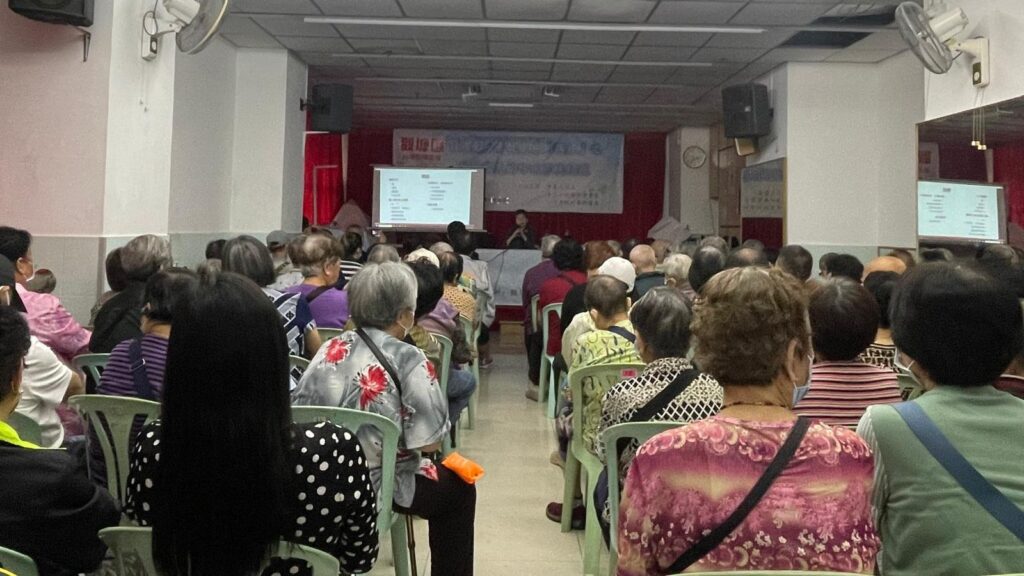 Elderly people watching Gloria present.