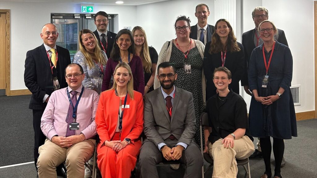 Teachers gathered whilst smiling.
