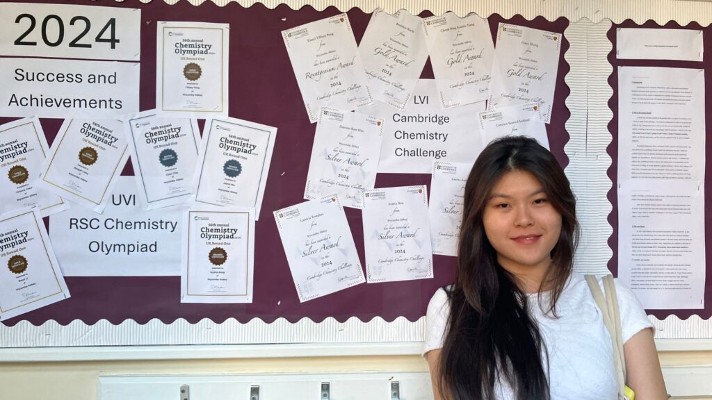 Tiffany stood in front of the display of Chemistry success.
