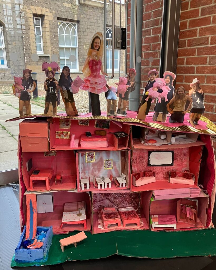 A pink cardboard Barbie house.