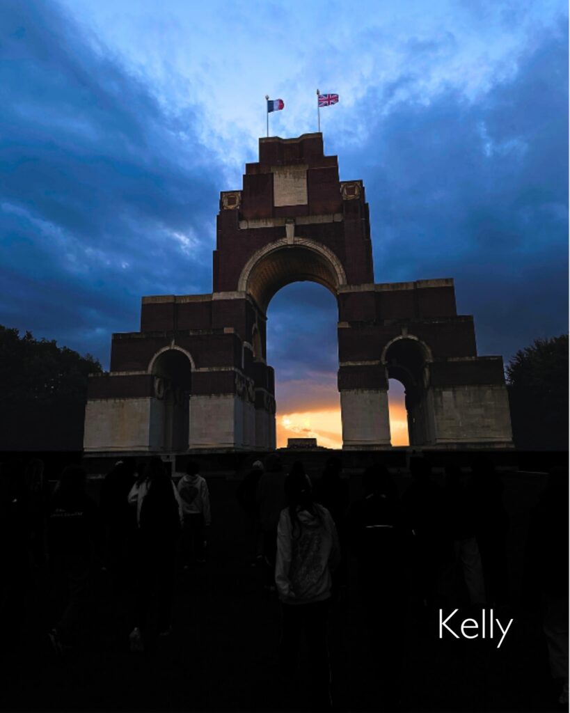 Kelly's photo of a yellow sky behinf the gates of a cemetery.