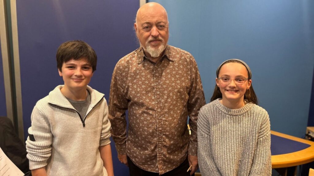Lilibet and her brother stood either side of Bill Bailey.