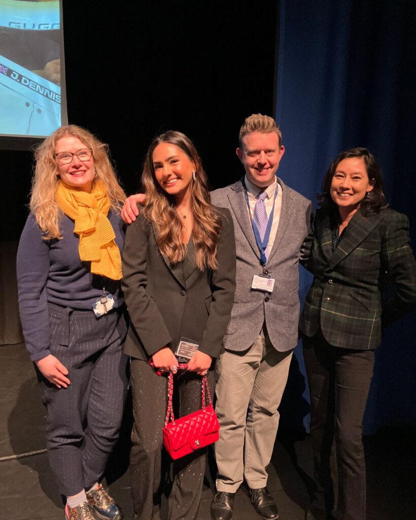 Lissie Mackintosh smiling with two of her previous teachers and her mum.