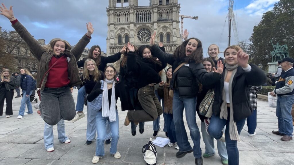 Pupils smiling and jumping together in Paris.
