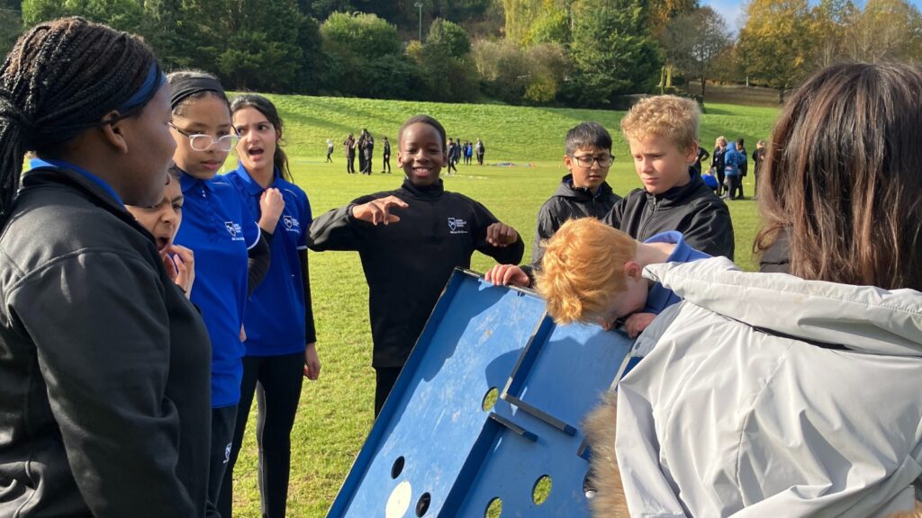 Pupils are taking part in a maze-based team building activity.