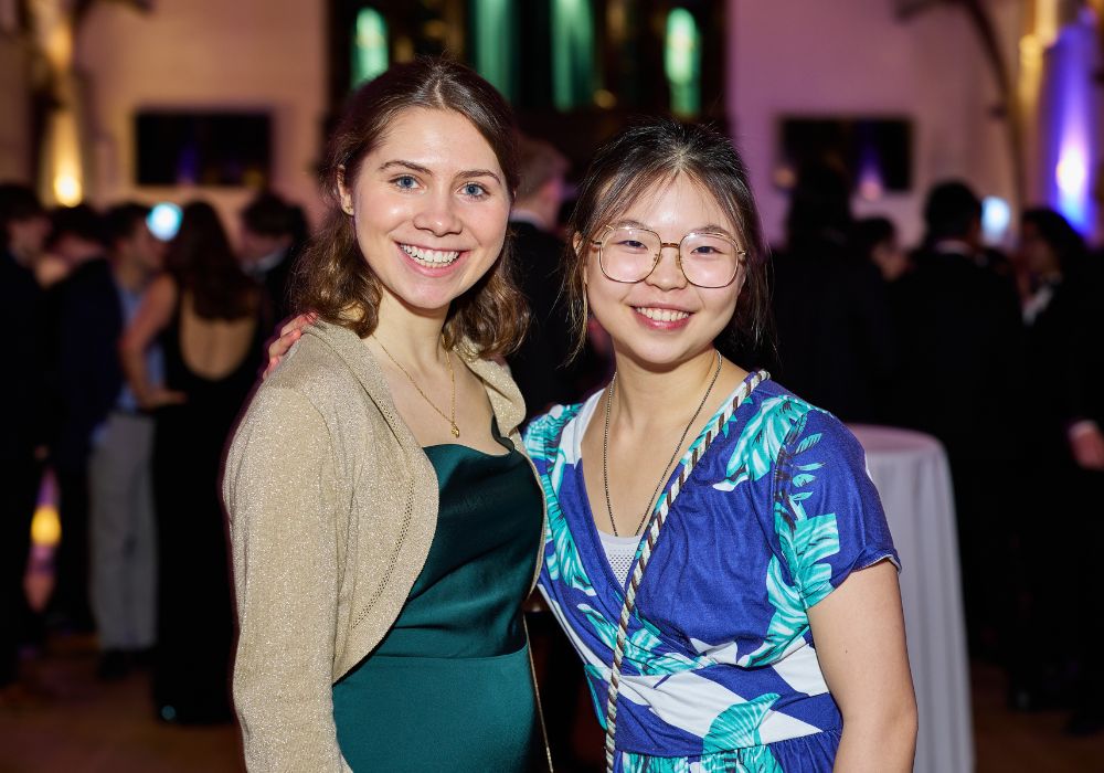Two pupils smiling in their ball gowns.