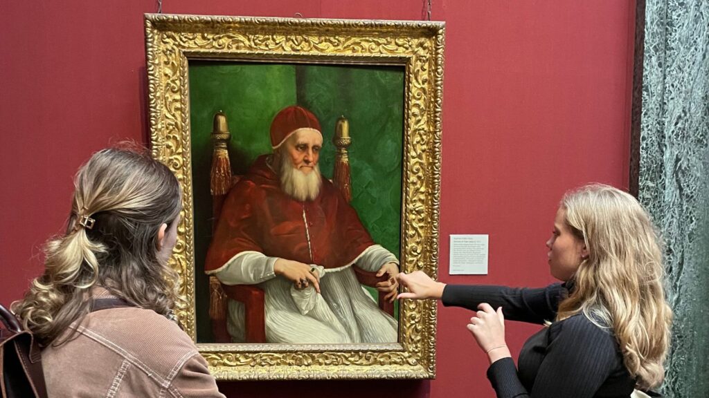 Two pupils admiring a painting in the 'Michelangelo, Leonardo, and Raphael' exhibition at the Royal Academy.
