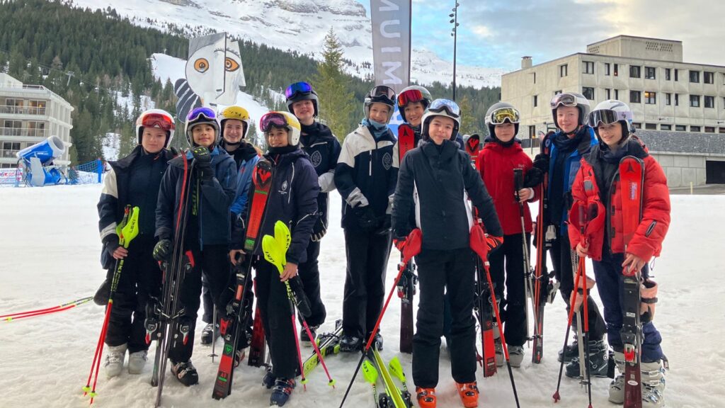 Pupils smiling in ski gear.