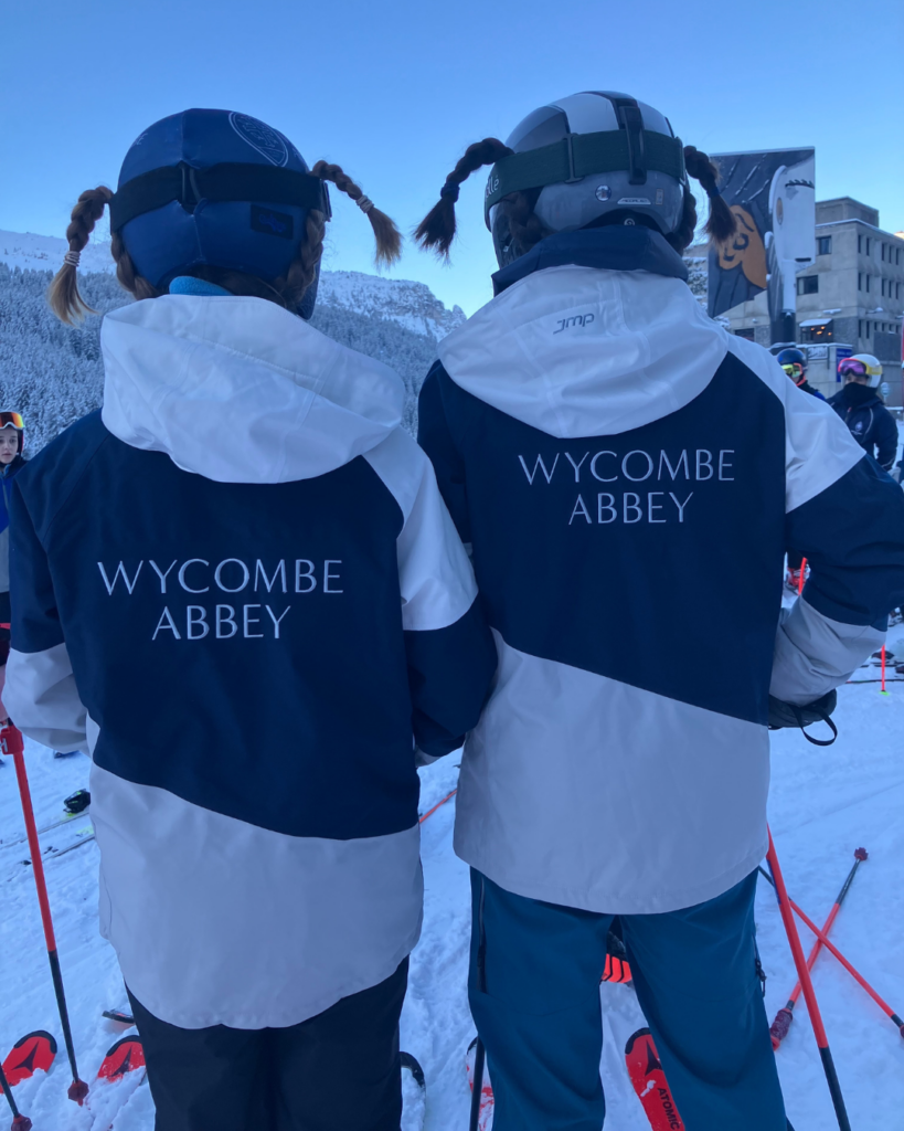 The backs of two pupils modelling the Wycombe Abbey ski jacket.
