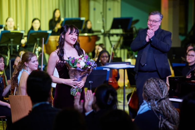 Sophia B holding flowers after she had sung her solo.