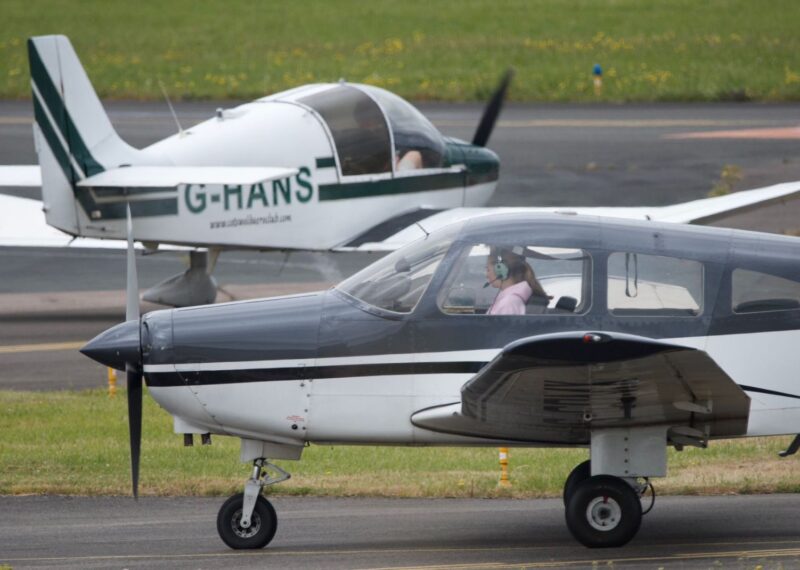 Avalon sat in a white and grey plane.