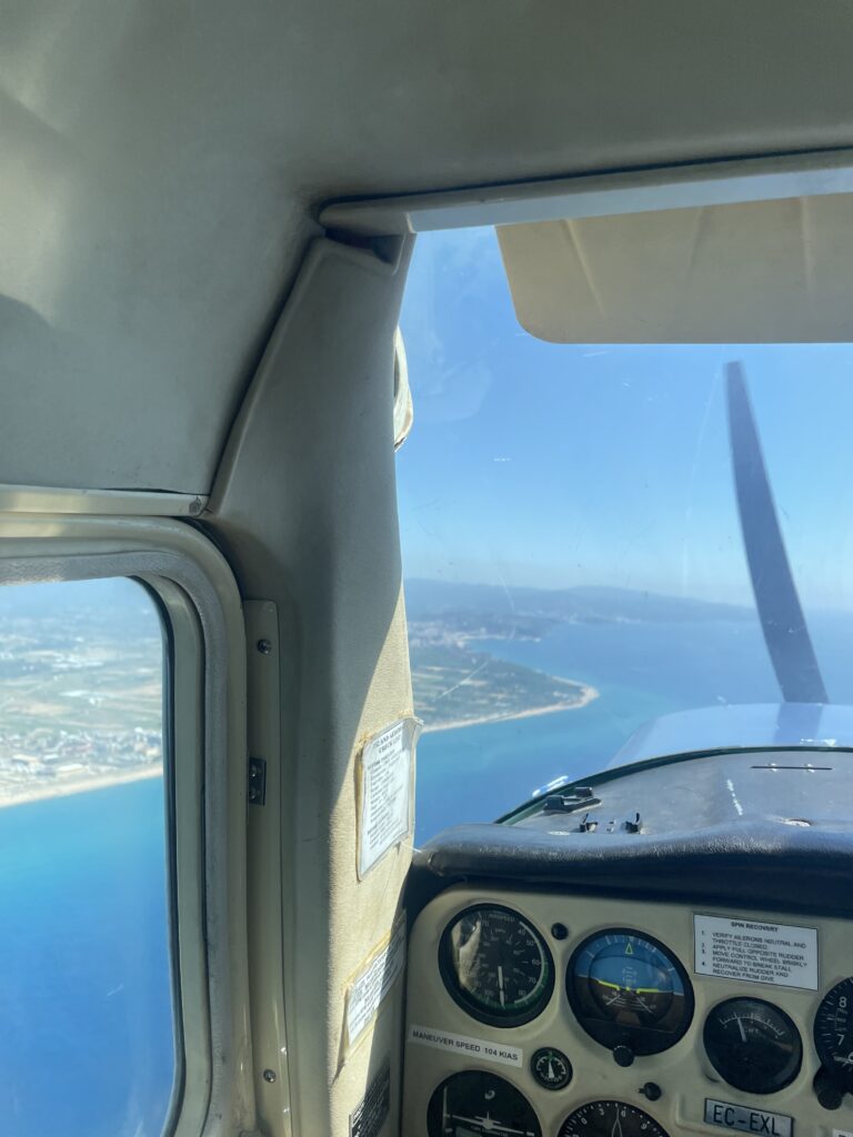 A view of the Barcelona coastline from the cockpit of Masha's plane.
