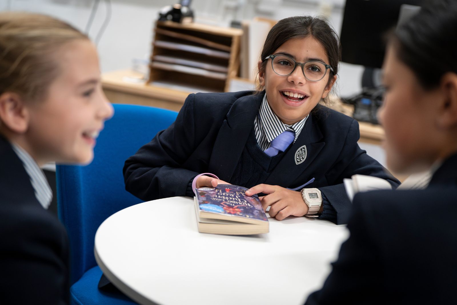 Pupils having a discussion around a table.