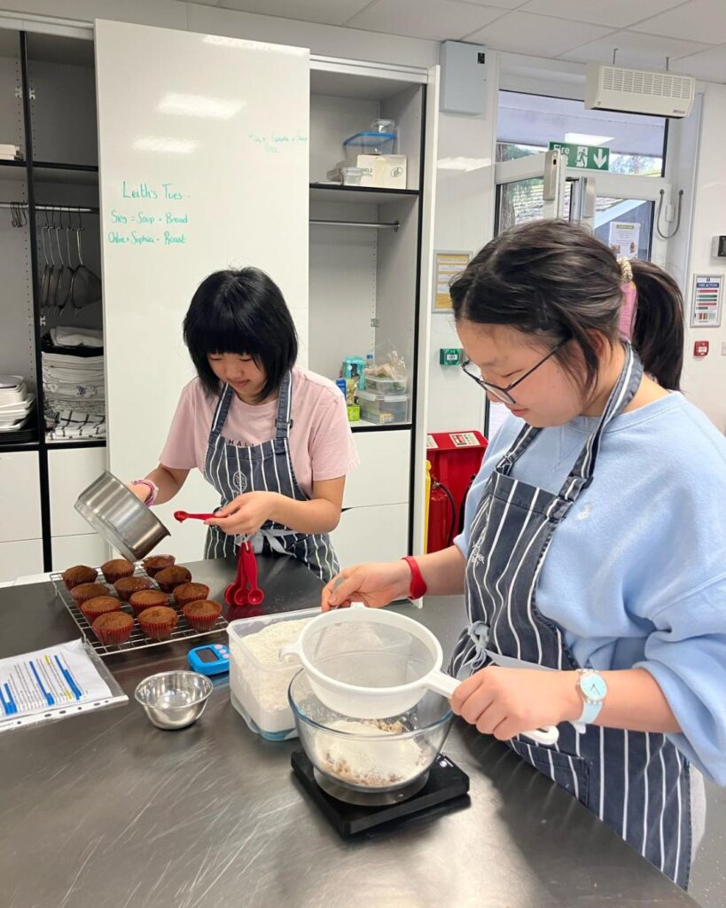 Girls making carrot cake.