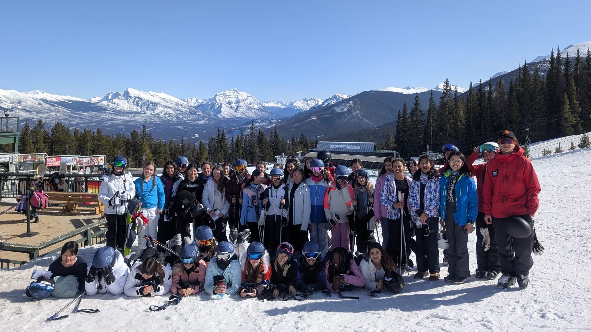 Pupils stood together at the bottom of the mountain with their skis.