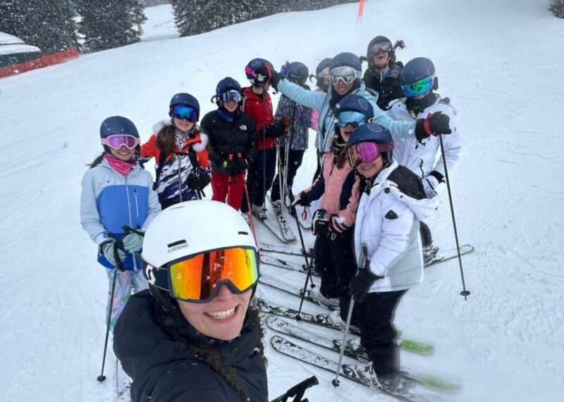 A selfie of pupils and their teacher whilst on skis.