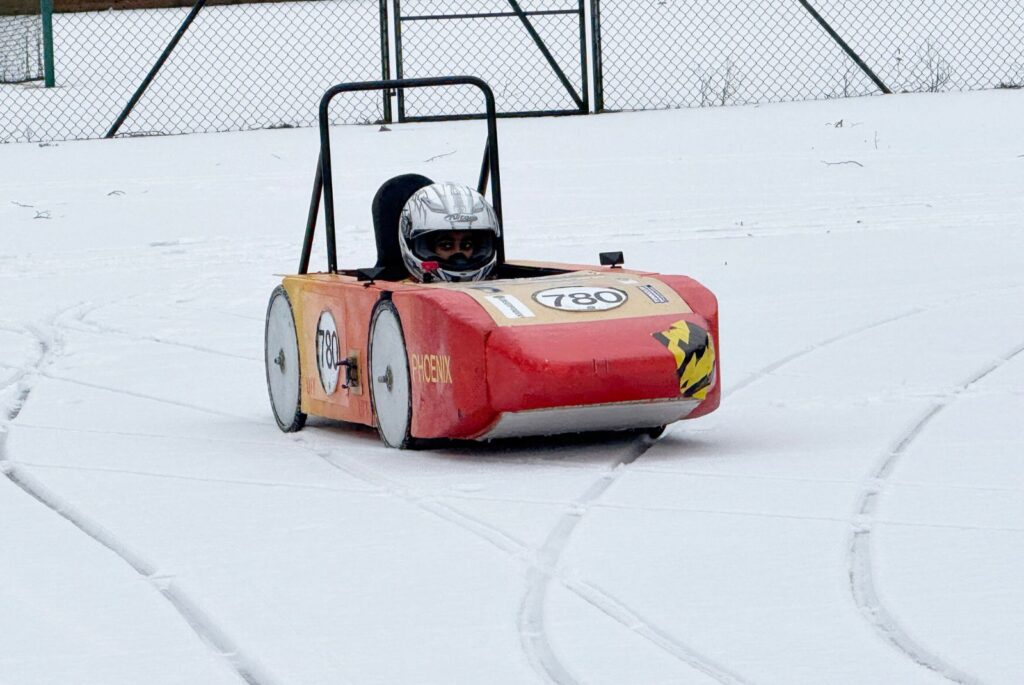 Wycombe Abbey's Greenpower car 'Phoenix' driving through the snow.