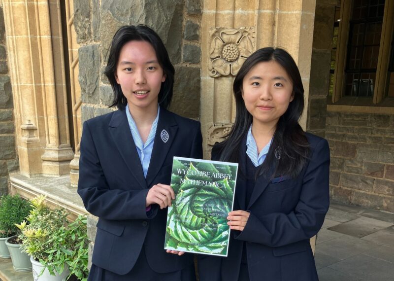 Cice and Judy holding a copy of Mathematica.