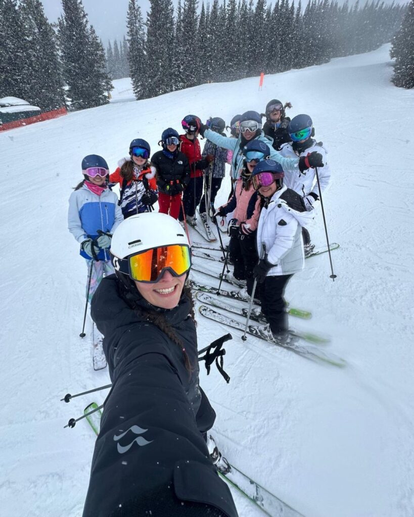 A selfie of pupils and their teacher whilst on their skis.
