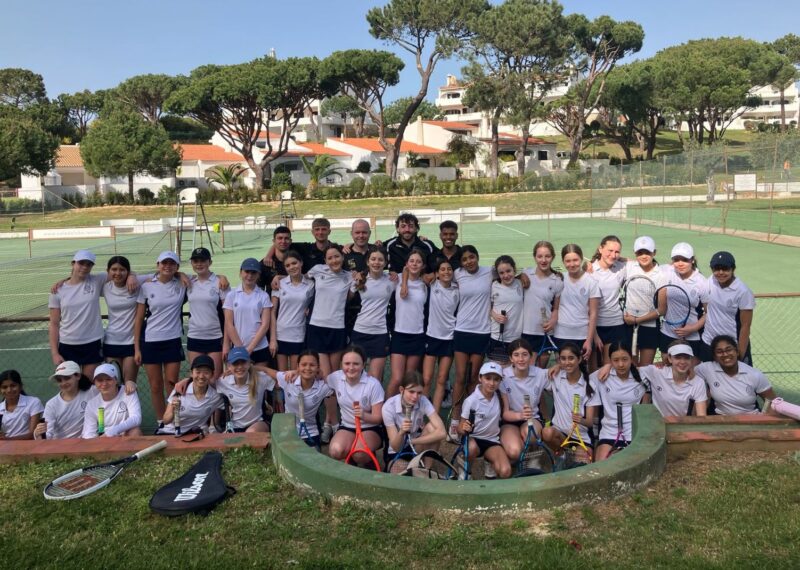 Pupils and their coaches stood beside the tennis courts.