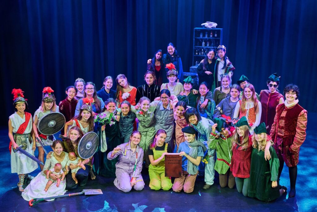 Fourth Form play participants in their costumes, all together on stage.