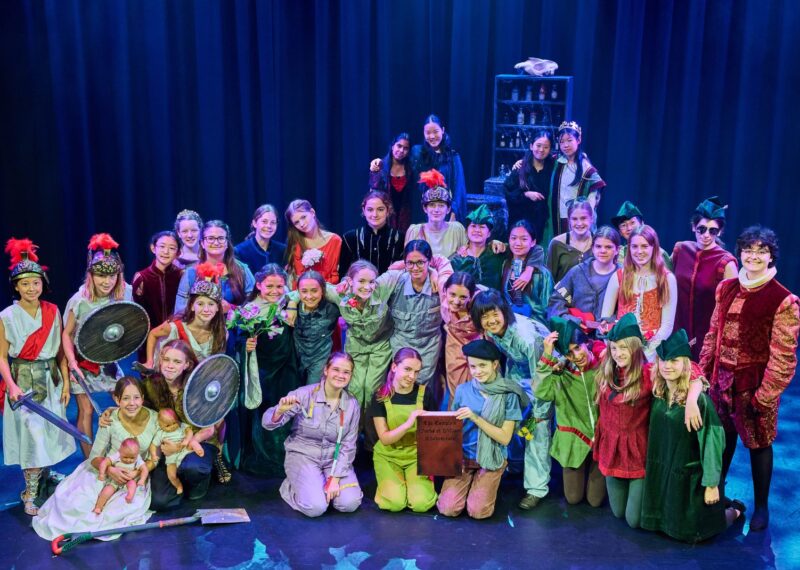 Fourth Form play participants in their costumes, all together on stage.