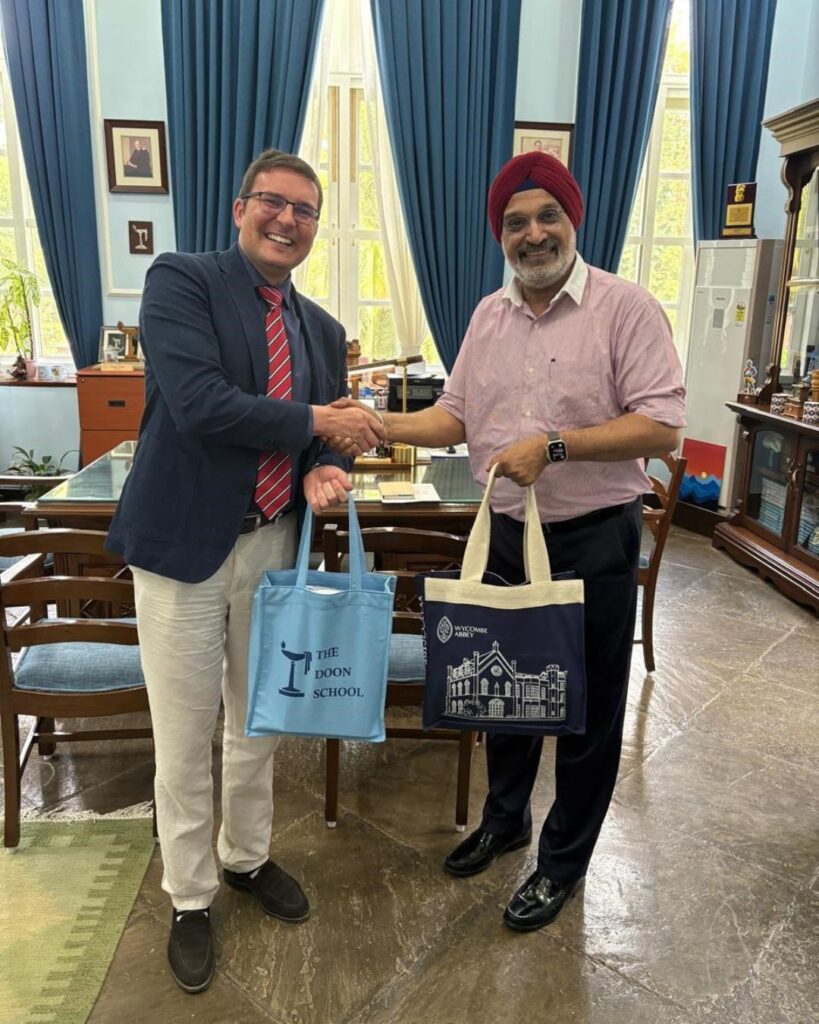 Nick swapping a Wycombe Abbey tote bag for a The Doon School tote bag with Dr Jagpreet Singh, Headmaster of the Doon School.