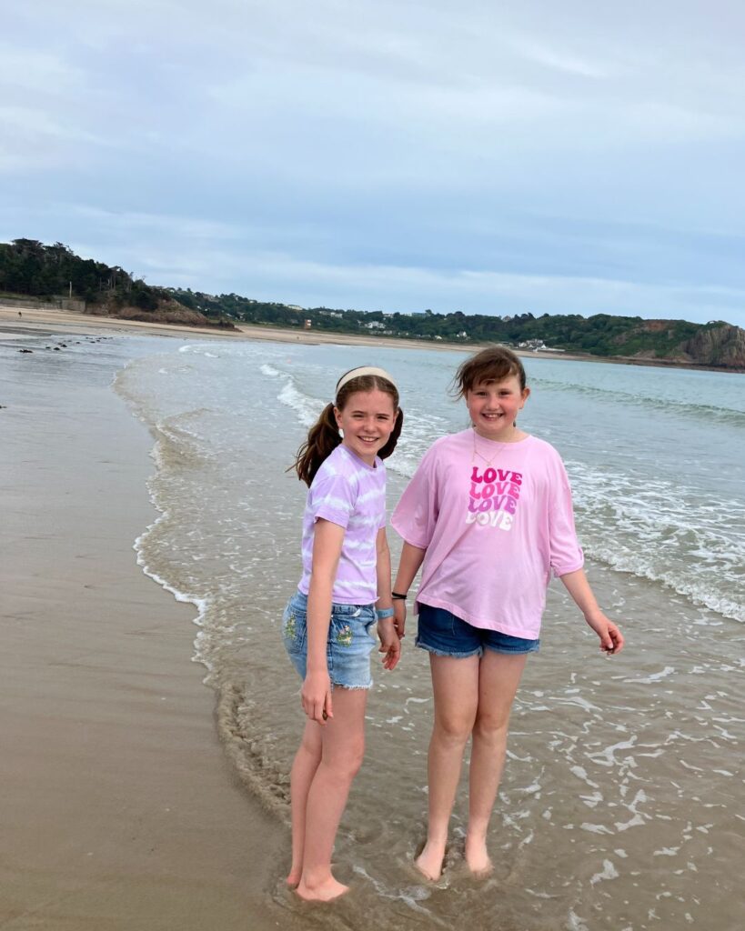 Two UIII pupils stood in the sea.