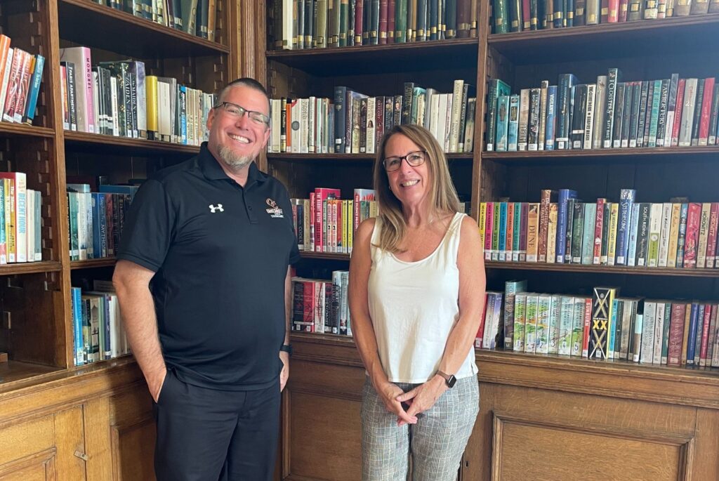 Brett and Mary Kay stood in front of a book case.