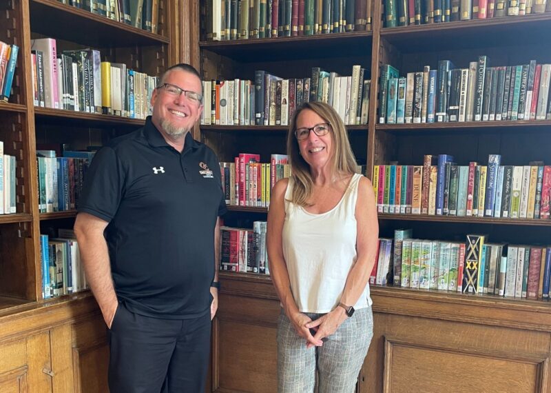 Brett and Mary Kay stood in front of a book case.