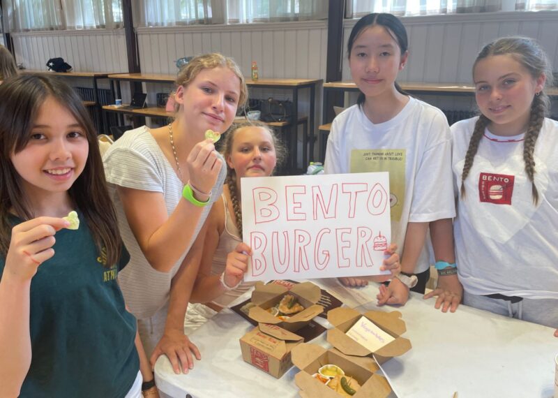 The Bento Burger team with their burgers and posters.