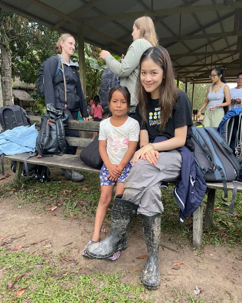 A Wycombe Abbey pupil sat next to a little girl.