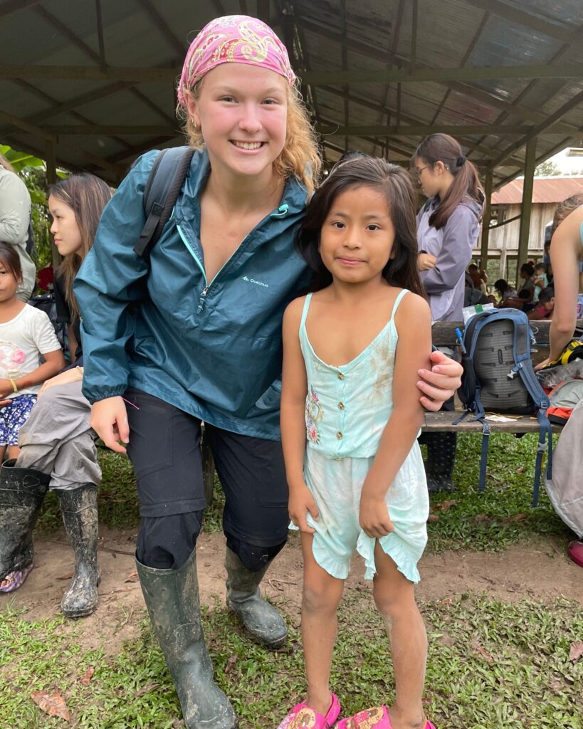 A Wycombe Abbey pupil with her arm around a little girl