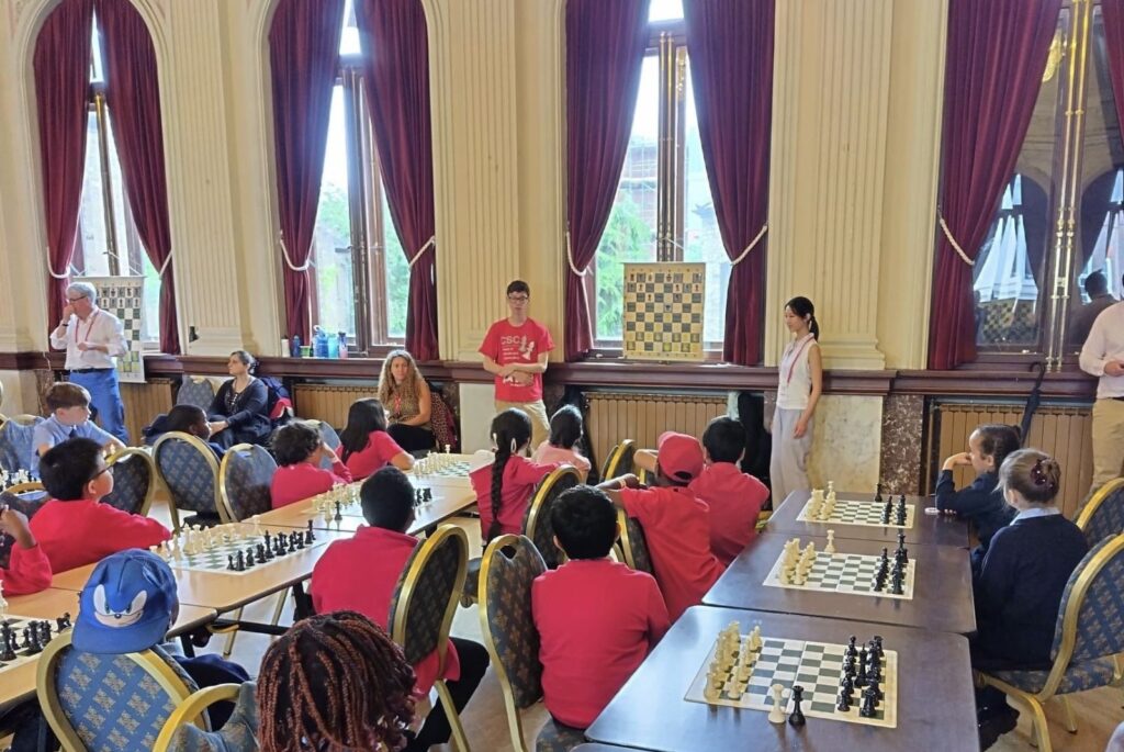 Emma and a fellow CSC ambassador teaching young children how to play chess.