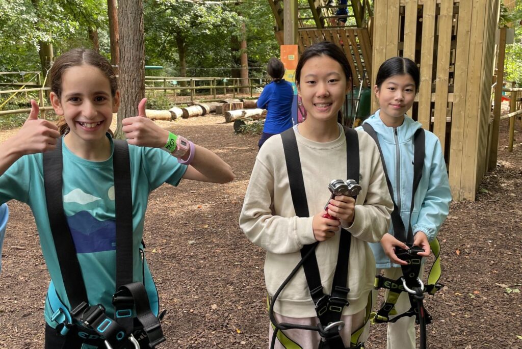 Pupils in their harnesses about to start the high ropes course.