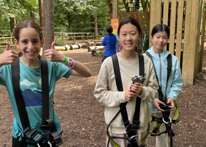 Pupils in their harnesses about to start the high ropes course.