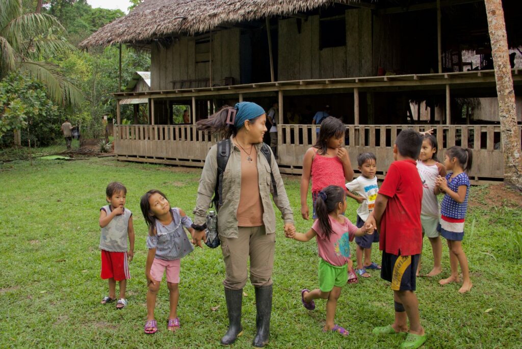Members of the indigenous community holding hands.