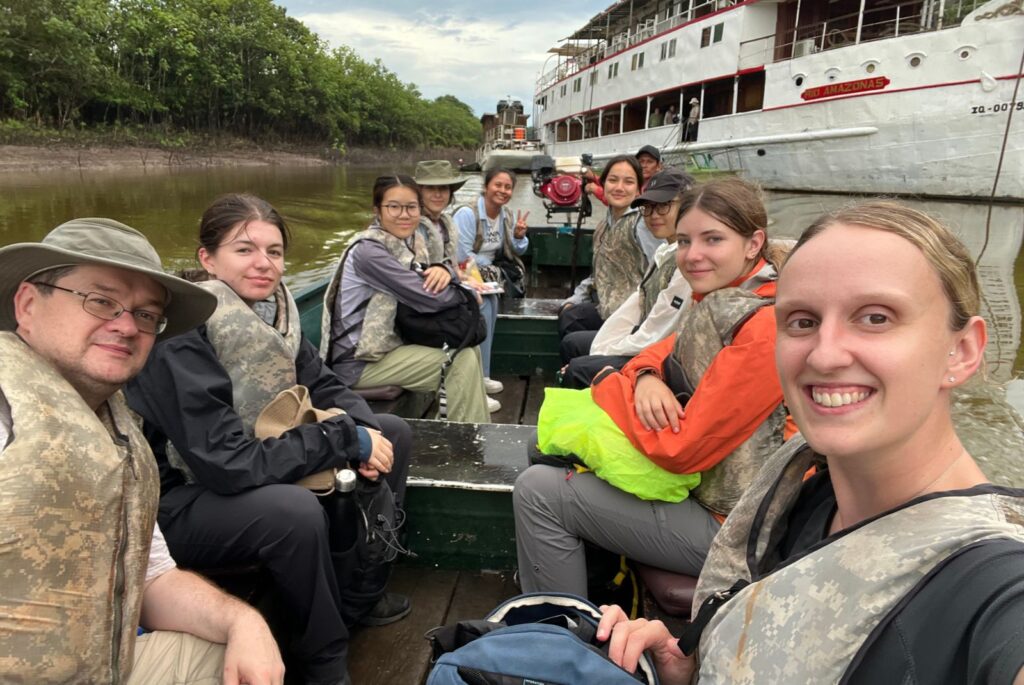 A selfie of Mr Whiteley, Miss Rowley and six pupils on a small boat.