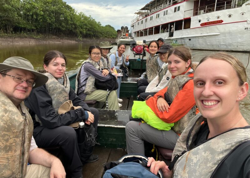 A selfie of Mr Whiteley, Miss Rowley and six pupils on a small boat.