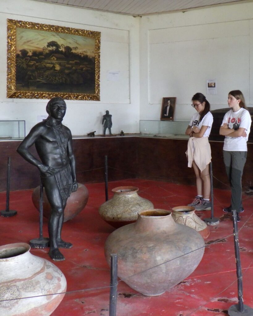 Pupils looking at statue in a museum.