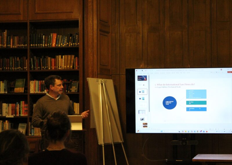 Man in library doing a presentation about law firm