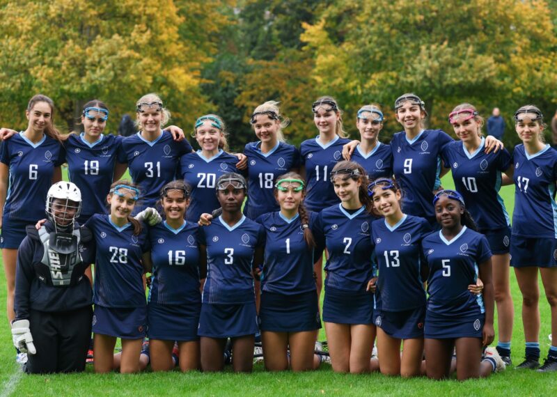 Group of Girls - AT A LACROSS GAME SMILING AND POSING FOR A TEAM PHOTO