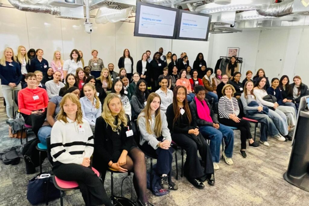 Group of girls sat in a room looking at the camera